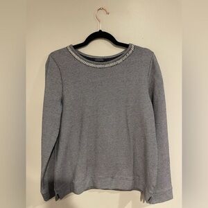 Size small Land’s End top embellished with a pearl collar.